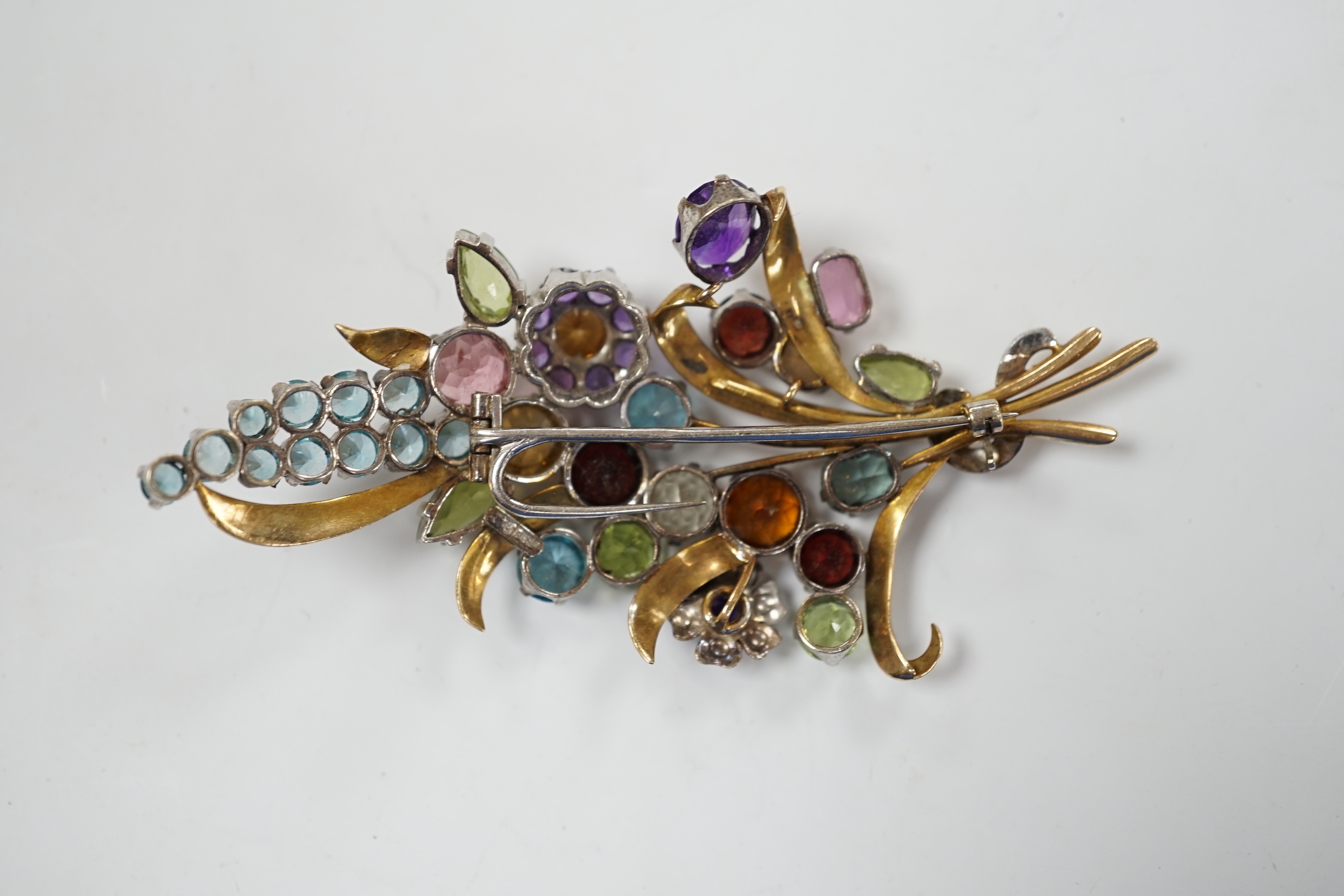 A 9ct and multi gem set floral spray brooch, including zircons, tourmaline and amethyst, by Cropp & Farr, 85mm gross weight 23.1 grams
